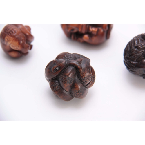 183 - A COLLECTION OF FOUR EARLY 20th CENTURY HARDWOOD BALL NETSUKE sculptured as various animals, three w... 