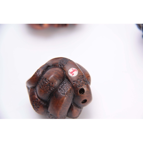 183 - A COLLECTION OF FOUR EARLY 20th CENTURY HARDWOOD BALL NETSUKE sculptured as various animals, three w... 