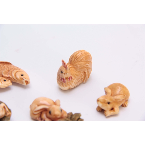 186 - A COLLECTION OF SEVEN EARLY 20TH CENTURY IVORY NETSUKE sculptured as rabbits, fish, hen, and octopus... 