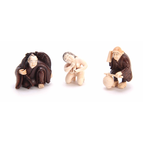 188 - A COLLECTION OF THREE EARLY 20th CENTURY IVORY AND HARDWOOD NETSUKE sculptured as various figures al... 