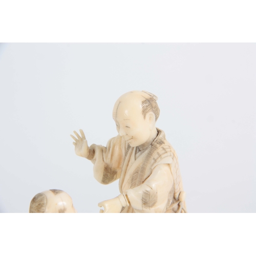 196 - A LATE 19TH CENTURY MEIJI JAPANESE  CARVED IVORY FIGURE GROUP modelled as a travelling Magician with... 