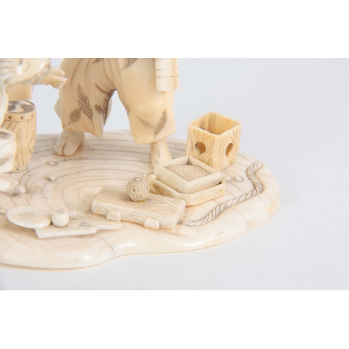 196 - A LATE 19TH CENTURY MEIJI JAPANESE  CARVED IVORY FIGURE GROUP modelled as a travelling Magician with... 