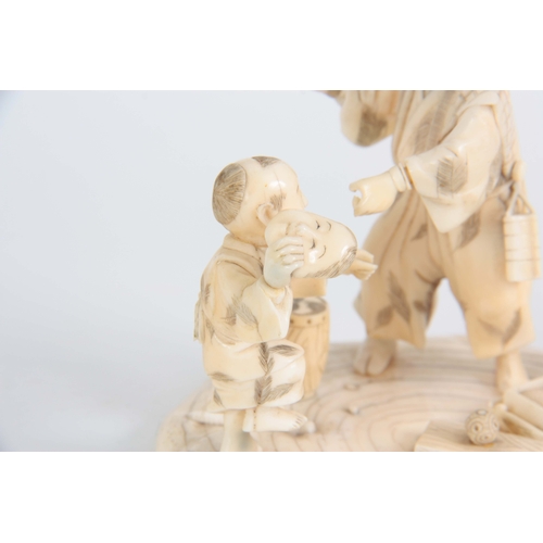 196 - A LATE 19TH CENTURY MEIJI JAPANESE  CARVED IVORY FIGURE GROUP modelled as a travelling Magician with... 