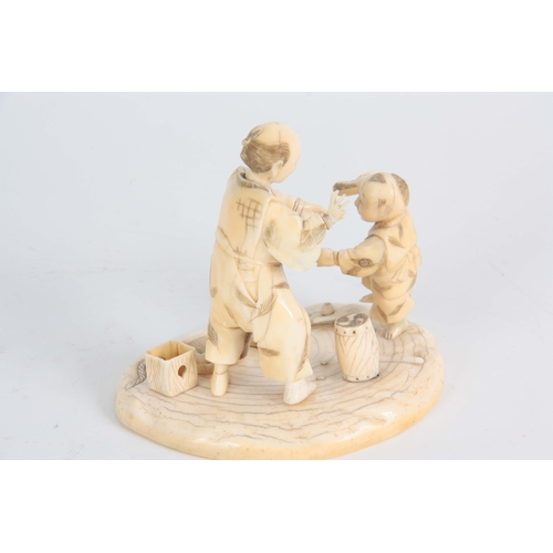 196 - A LATE 19TH CENTURY MEIJI JAPANESE  CARVED IVORY FIGURE GROUP modelled as a travelling Magician with... 