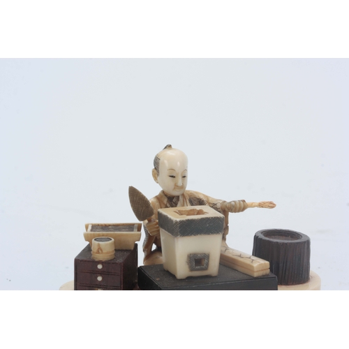 199 - A JAPANESE MEIJI PERIOD IVORY AND STAINED IVORY OKIMONO the seated figure modelled as a brickmaker w... 