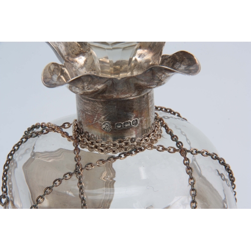 20 - A GEORGE V SILVER MOUNTED SPIRIT DECANTER AND STOPPER with quatrefoil pouring lips and pinched clear... 