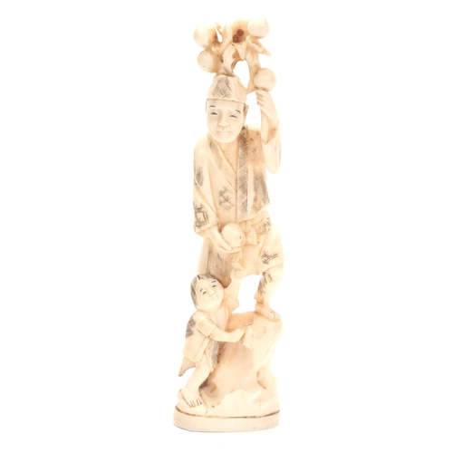 201 - A JAPANESE MEIJI PERIOD IVORY OKIMONO modelled as a father and child carrying fruit 21cm high, signe... 