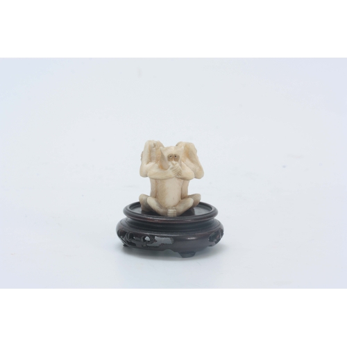 208 - AN EARLY 20th CENTURY CHINESE IVORY CARVING modelled as three carved monkeys back to back posed as h... 