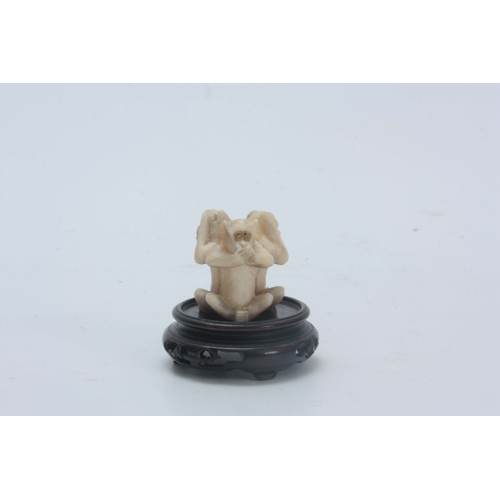 208 - AN EARLY 20th CENTURY CHINESE IVORY CARVING modelled as three carved monkeys back to back posed as h... 