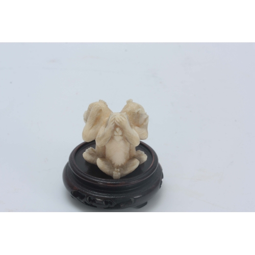 208 - AN EARLY 20th CENTURY CHINESE IVORY CARVING modelled as three carved monkeys back to back posed as h... 