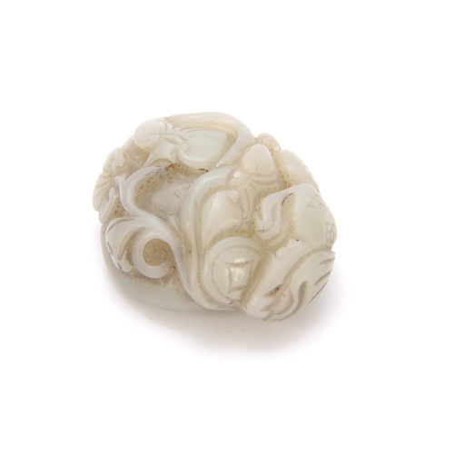 210 - A CHINESE CARVED JADE SCULPTURE depicting a dragon with floral work decoration 5cm wide 4cm deep.