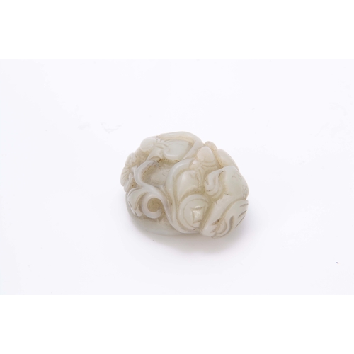 210 - A CHINESE CARVED JADE SCULPTURE depicting a dragon with floral work decoration 5cm wide 4cm deep.