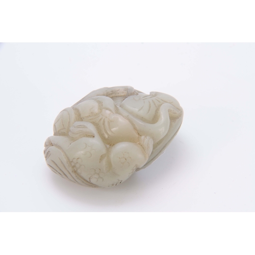 210 - A CHINESE CARVED JADE SCULPTURE depicting a dragon with floral work decoration 5cm wide 4cm deep.