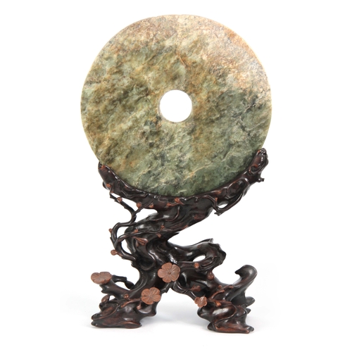 213 - A LARGE 18th/19th CENTURY CHINESE JADE PI ON HARDWOOD STAND the large circular spinach green jade wi... 