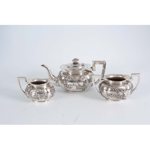 224 - A 19TH CENTURY CHINESE THREE-PIECE SILVER TEA SERVICE of oblate panelled form with folded rims, each... 