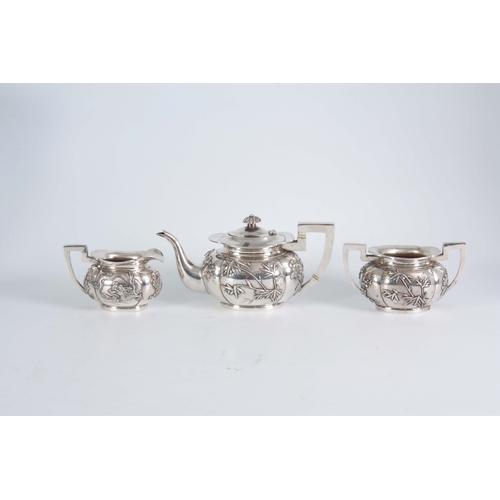 224 - A 19TH CENTURY CHINESE THREE-PIECE SILVER TEA SERVICE of oblate panelled form with folded rims, each... 