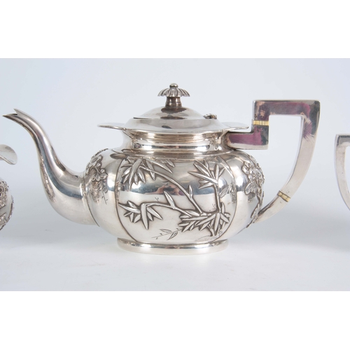 224 - A 19TH CENTURY CHINESE THREE-PIECE SILVER TEA SERVICE of oblate panelled form with folded rims, each... 