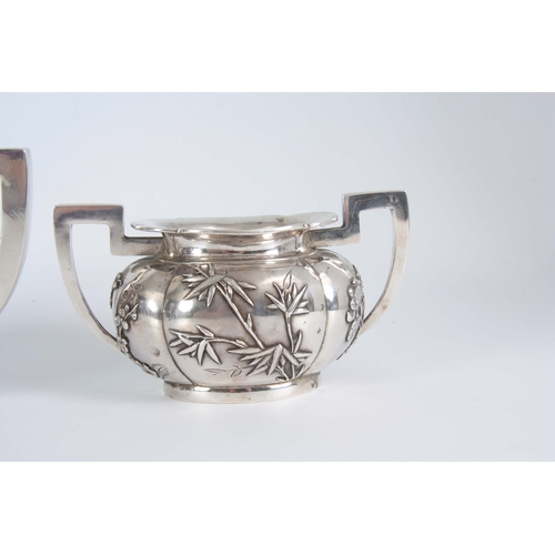 224 - A 19TH CENTURY CHINESE THREE-PIECE SILVER TEA SERVICE of oblate panelled form with folded rims, each... 