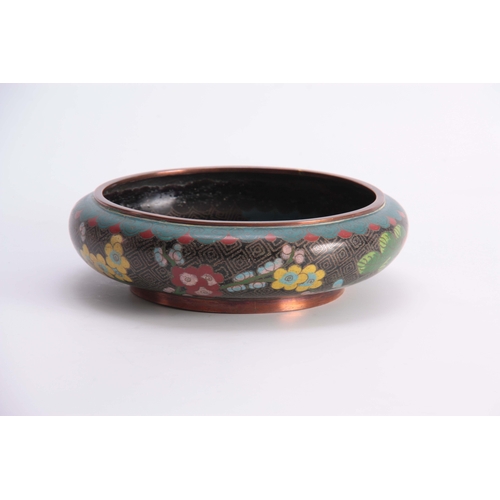 229 - A CHINESE CLOISONNE ENAMEL SHALLOW FOOTED BOWL with overall flower spray decoration on a black and b... 