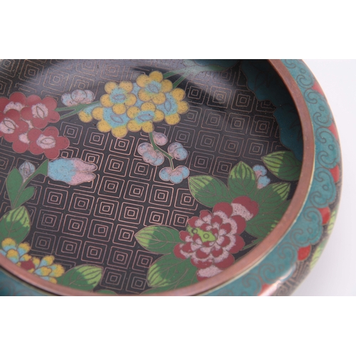 229 - A CHINESE CLOISONNE ENAMEL SHALLOW FOOTED BOWL with overall flower spray decoration on a black and b... 