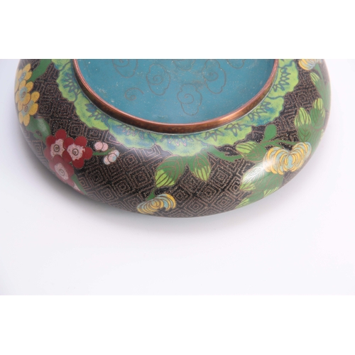 229 - A CHINESE CLOISONNE ENAMEL SHALLOW FOOTED BOWL with overall flower spray decoration on a black and b... 