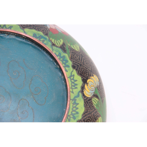 229 - A CHINESE CLOISONNE ENAMEL SHALLOW FOOTED BOWL with overall flower spray decoration on a black and b... 