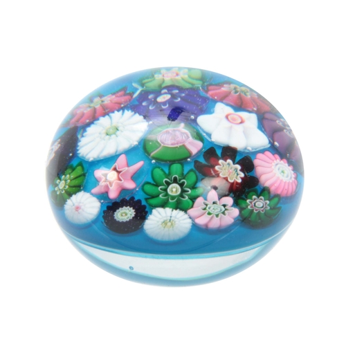 4 - A MID 19TH CENTURY CLICHY PAPERWEIGHT turquoise ground decorated with flower heads 6cm diameter.