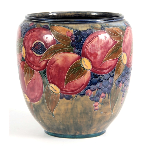 43 - A 20TH CENTURY MOORCROFT  JARDINIERE decorated with pomegranates and grapes bearing green signature ... 