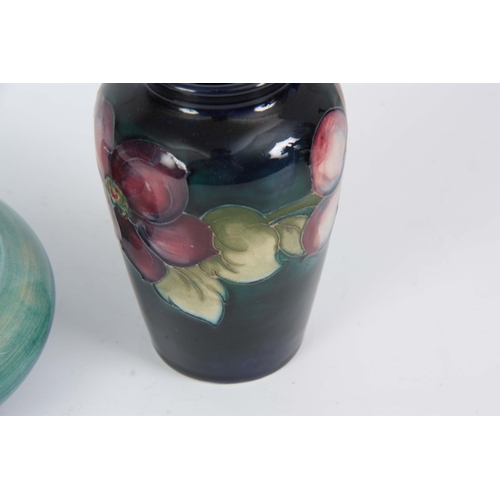 49 - A 1930's MOORCROFT SMALL TAPERING SHOULDERED VASE tube lined and decorated with a continuous band of... 