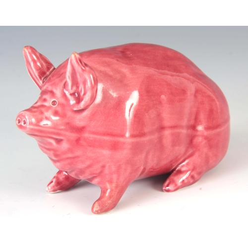 54 - A WEMYSS WARE PIG CIRCA 1900 having a pink glaze with impressed marks to underside 16.5cm wide