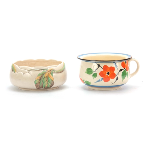 57 - TWO PIECES OF 1930'S CLARICE CLIFF POTTERY comprising a fantasque chamber pot decorated with leaves ... 