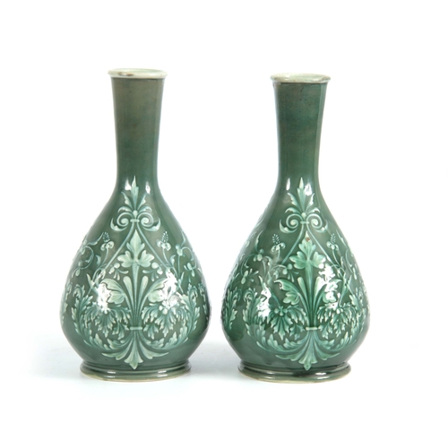 59 - A PAIR OF 19TH CENTURY DOULTON LAMBETH PATE SUR PATE DECORATED VASES decorated with foliage bearing ... 