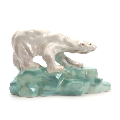 63 - A WADE PORCELAIN MODEL OF A POLAR BEAR BY FAUST LANG standing on a rocky base signed `Wade Figures` ... 