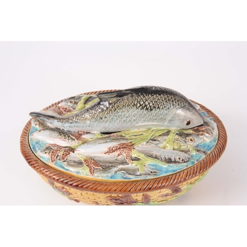 66 - A LATE 19th CENTURY MAJOLICA SARDINE DISH AND COVER IN THE MANNER OF GEORGE JONES the oval lid surmo... 