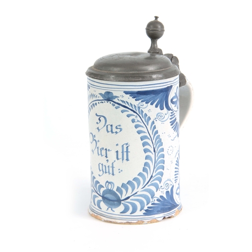 87 - AN 18TH CENTURY GERMAN BLUE AND WHITE PEWTER MOUNTED DELFT TANKARD bearing inscription ‘Das bie ift ... 