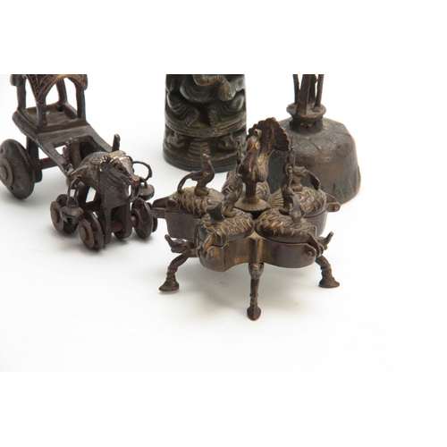 234 - A GROUP OF FOUR EASTERN CAST BRONZE TEMPLE TOYS depicting elephants, peacocks and a bell 13.5cm high... 