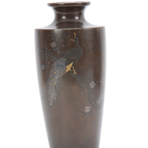 235 - A JAPANESE MEIJI PERIOD BRONZE AND INLAID MIXED METAL TAPERING VASE depicting a peacock sat in branc... 