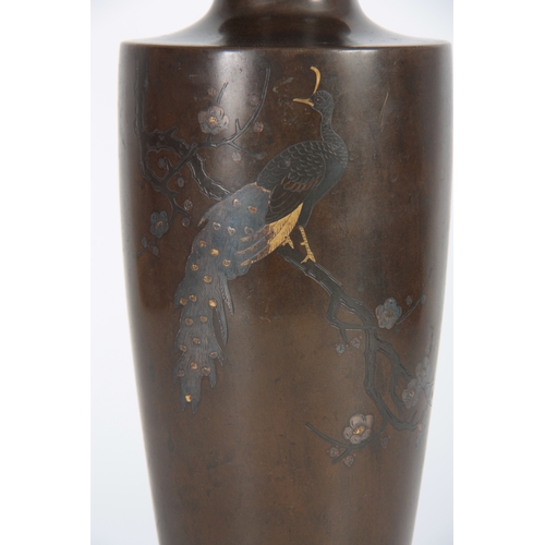 238 - A JAPANESE MEIJI PERIOD BRONZE AND INLAID MIXED METAL TAPERING VASE depicting a peacock sat in branc... 