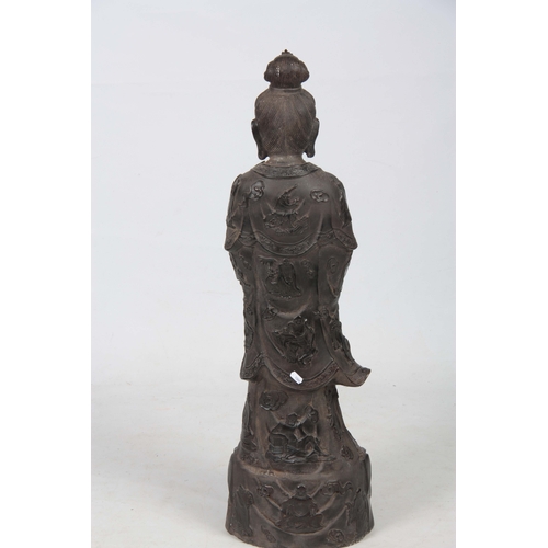 241 - A 19TH CENTURY CHINESE BRONZE FIGURE OF GUANYIN mounted on a naturalistic base 96cm high.