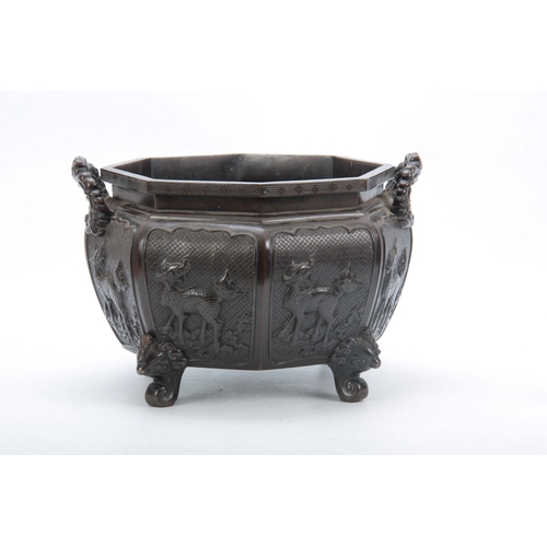 244 - A 18/19th CENTURY CHINESE OXTAGANOL PATINATED BRONZE JARDINIERE having a panelled body with raised d... 