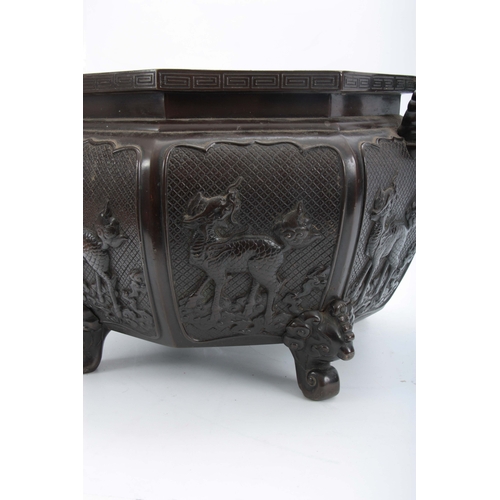 244 - A 18/19th CENTURY CHINESE OXTAGANOL PATINATED BRONZE JARDINIERE having a panelled body with raised d... 