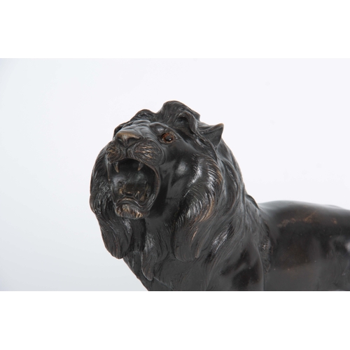 250 - A JAPANESE MEIJI PERIOD PATINATED BRONZE SCULPTURE modelled as a lion with amber glass eyes, charact... 