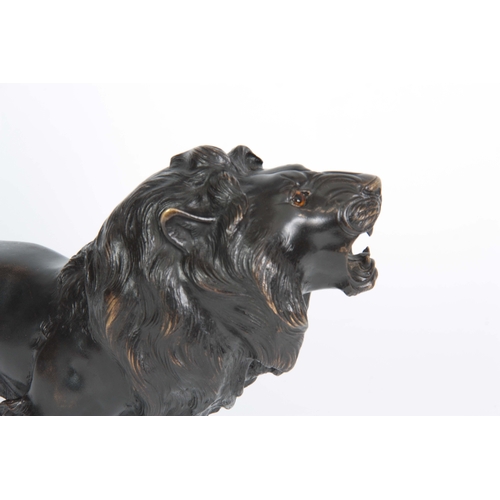 250 - A JAPANESE MEIJI PERIOD PATINATED BRONZE SCULPTURE modelled as a lion with amber glass eyes, charact... 