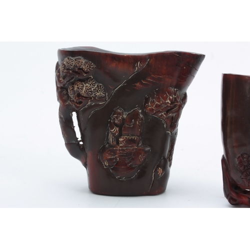 266 - TWO CHINESE CARVED HORN LIBATION CUPS the larger decorated with blossoming trees and figures 9cm hig... 