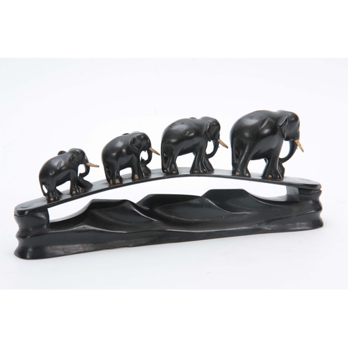 267 - A LATE 19TH CENTURY EBONY CARVED SCULPTURE OF ELEPHANTS mounted on naturalistic carved base, with iv... 