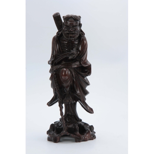 277 - A 19TH CENTURY CHINESE HARDWOOD STANDING FIGURE with finely detailed decoration 43cm high