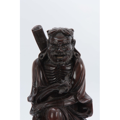 277 - A 19TH CENTURY CHINESE HARDWOOD STANDING FIGURE with finely detailed decoration 43cm high