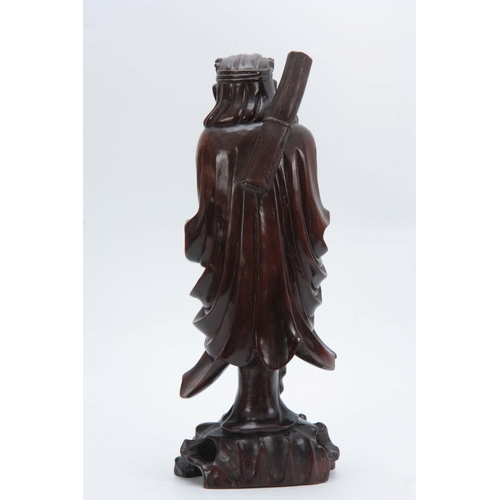 277 - A 19TH CENTURY CHINESE HARDWOOD STANDING FIGURE with finely detailed decoration 43cm high