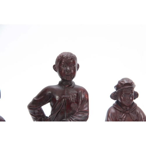 278 - A SET OF FOUR CHINESE CULTURAL REVOLUTION CARVED HARDWOOD FIGURES modelled as boys and girls dressed... 