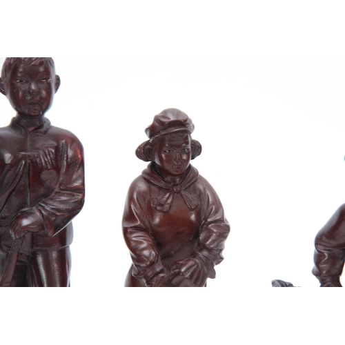 278 - A SET OF FOUR CHINESE CULTURAL REVOLUTION CARVED HARDWOOD FIGURES modelled as boys and girls dressed... 